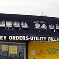 The gashes in this awning reveal the name of another business that once occupied this space.