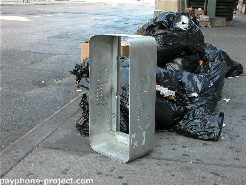 Payphone enclosure left out for trash