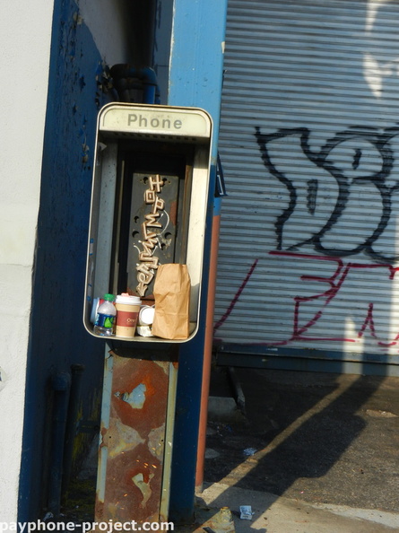 Abandoned payphone enclosure. Queens Boulevard. Sunnyside, Queens.