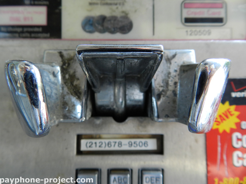 (212) 678-9506 is the phone number for the payphone inside one of the last outdoor, free-standing phone booths in New York City.