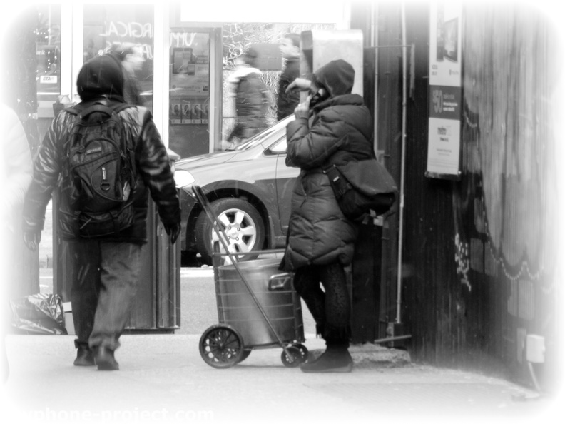 Talking on an American Payphone as snow starts to fall.