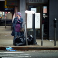 Smiling girl talking on a payphone