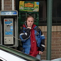 Woman using an American brand payphone