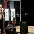 Man talking on a payphone