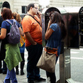 57th Street. Face to face payphone users outside the Trump Tower