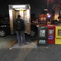 A well-lit payphone enclosure on Broadway
