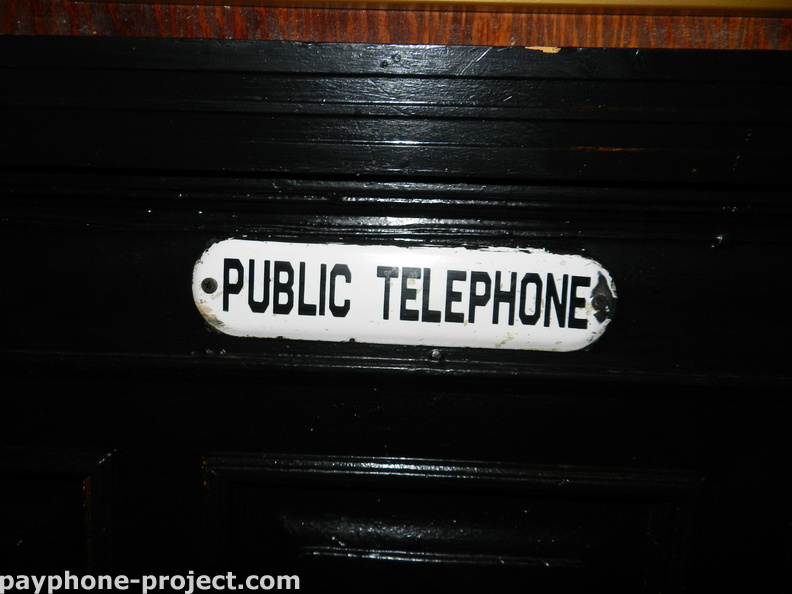 This "PUBLIC TELEPHONE" sign leads you to an abandoned, non-working Verizon payphone in the basement of Pete's Tavern.