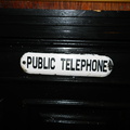 This "PUBLIC TELEPHONE" sign leads you to an abandoned, non-working Verizon payphone in the basement of Pete's Tavern.