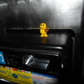 I spotted this smiling basketball-player figurine on a payphone.