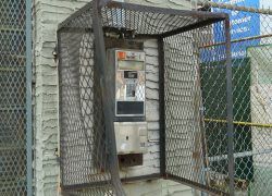 Abandoned Payphone in a Cage