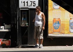Cell Phone in Hand, Standing By the Payphone