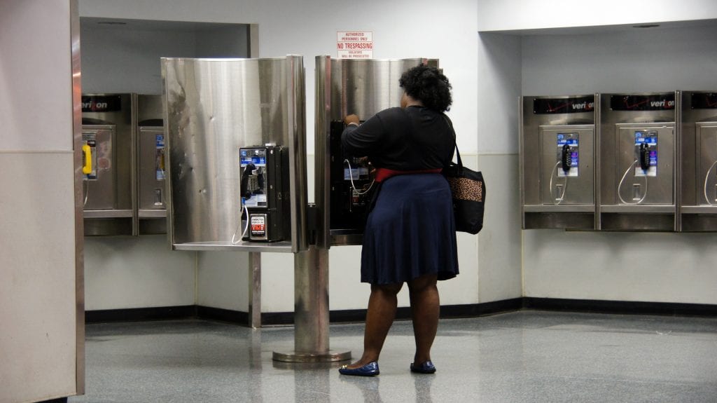 Woman Using a Penn Station Payphone