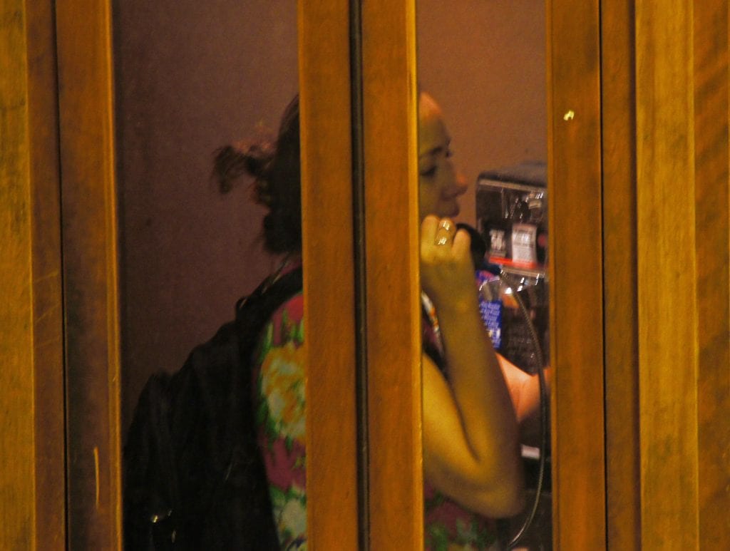 Woman Using a Manhattan Phone Booth