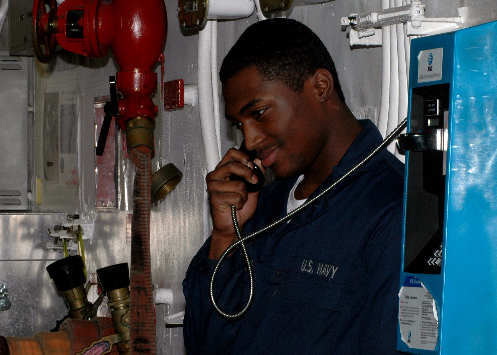 Archives.gov: Aviation Ordnanceman AIRMAN Apprentice Kyrie Jon’Francis talks on a pay phone