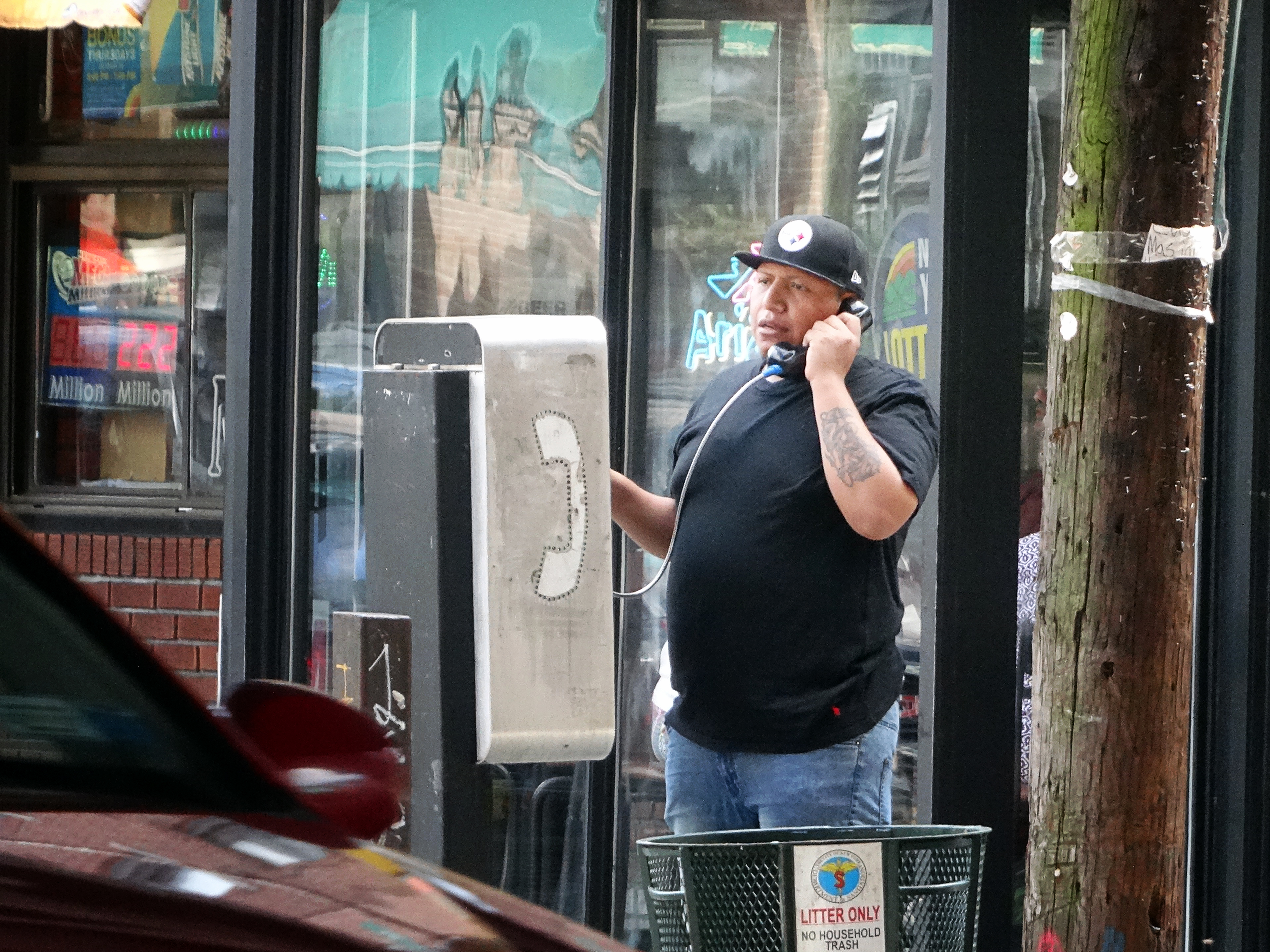 Action Shot: Payphone User in Astoria