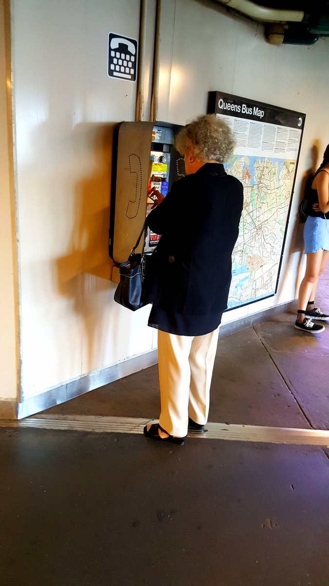 Action Shot: Payphone Customer at the Queens 74th St./Broadway Station