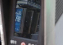 Reflection of Two Working Payphones in a Non-Working LinkNYC Tablet Screen