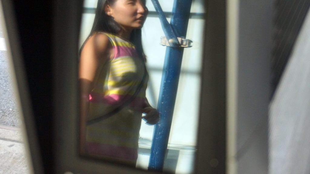 Woman's Reflection in the Tablet Screen of a Non-Working LinkNYC Kiosk